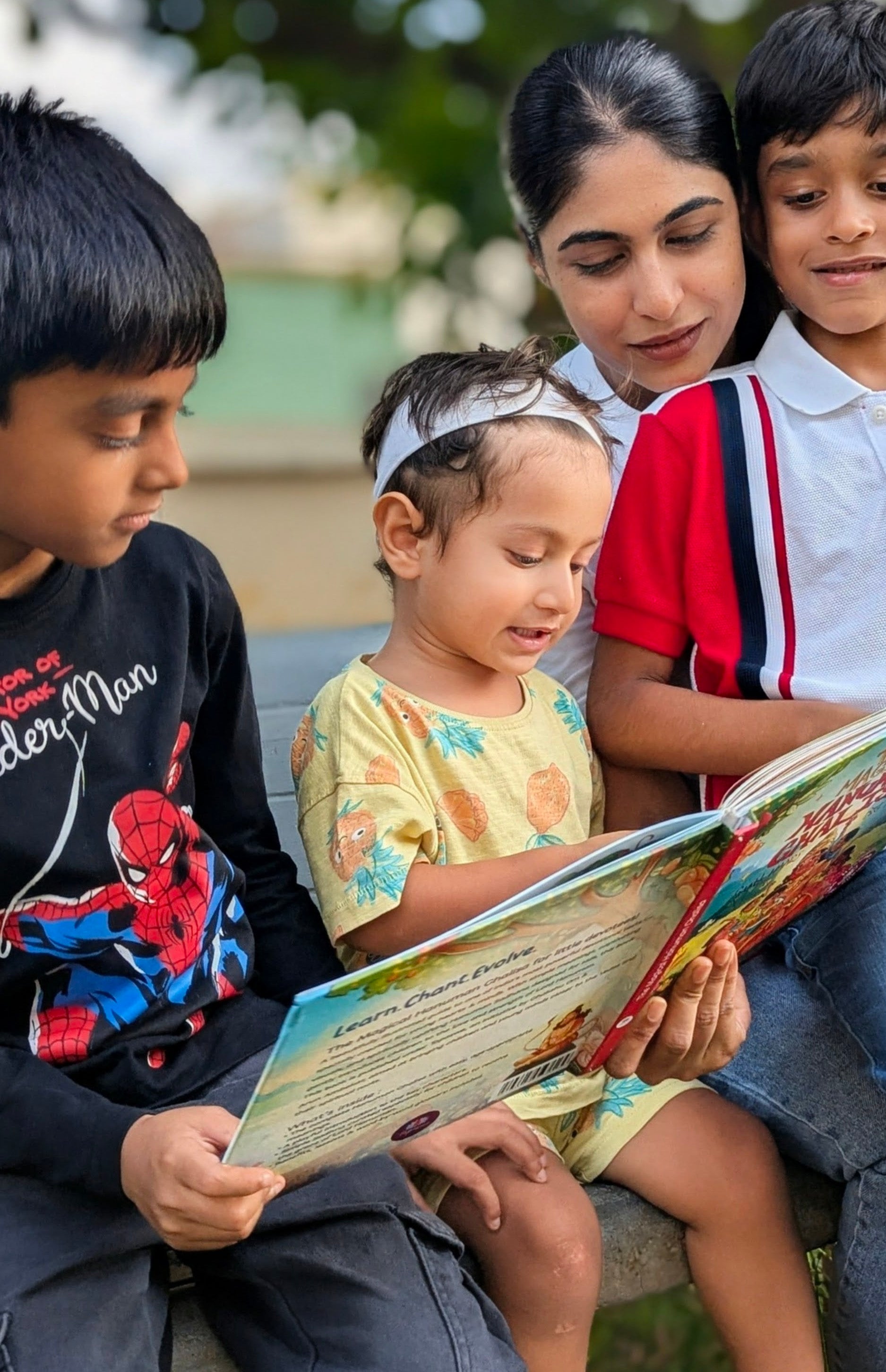 Parent reading the Chalisa with a toddler